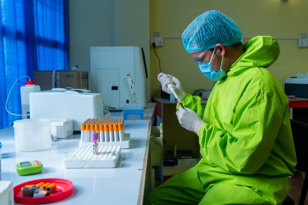Laboratory technician handling trial samples during site close-out and inspection preparation