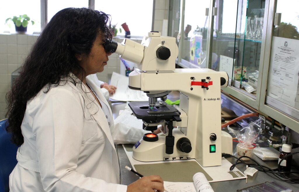 Clinical research associate reviewing samples at an Indian clinical trial site laboratory